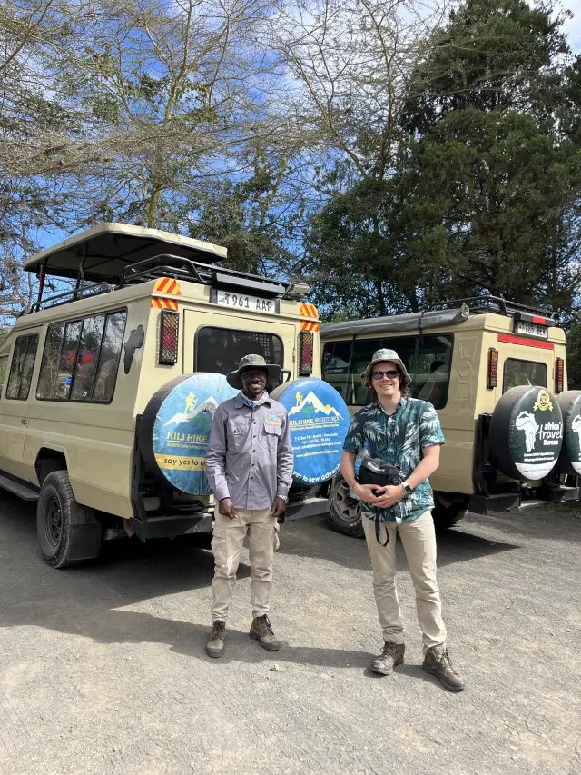 Two happy travellers and our safari fleet
